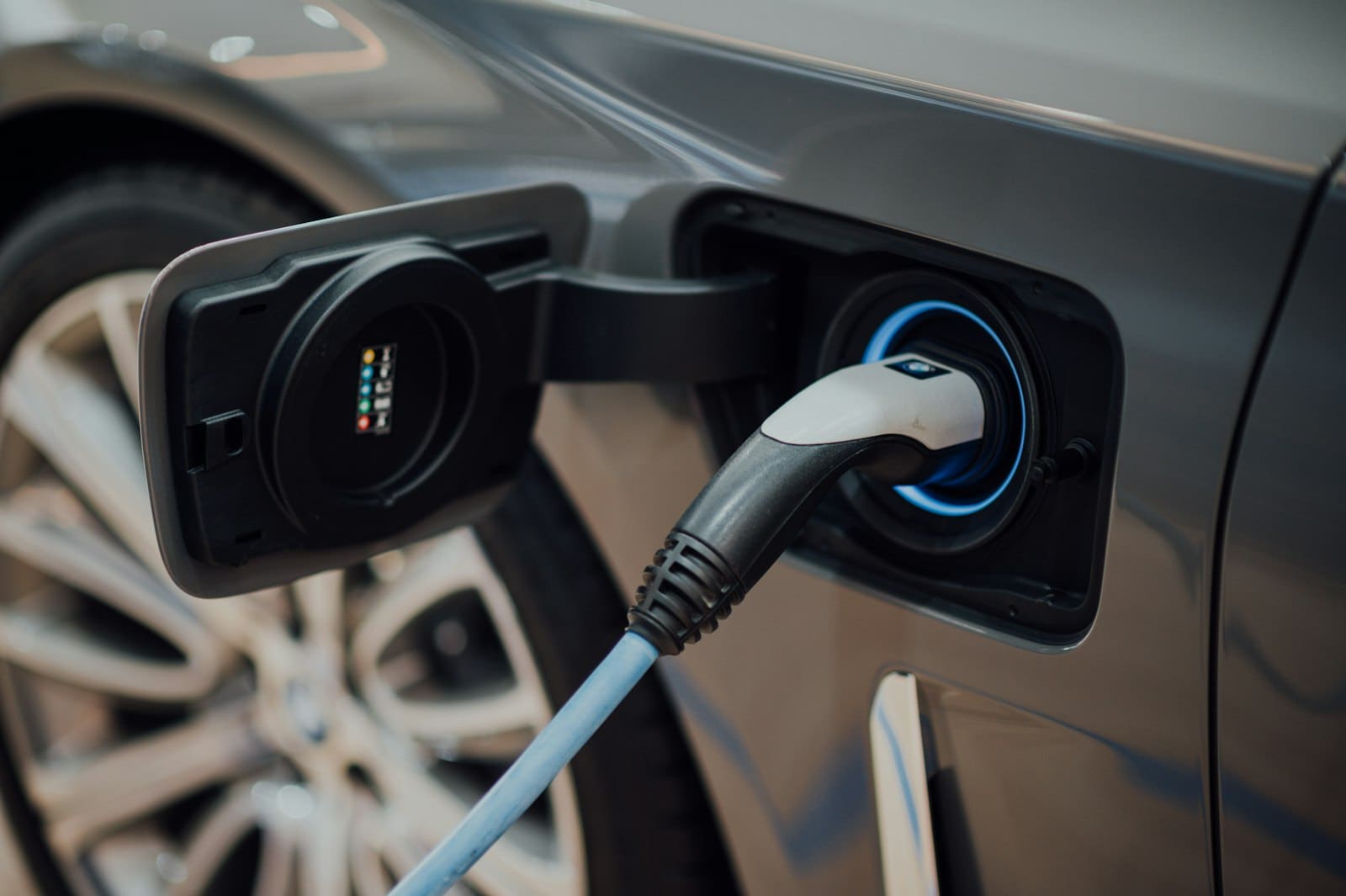 Electric vehicle charging connector plugged into a car