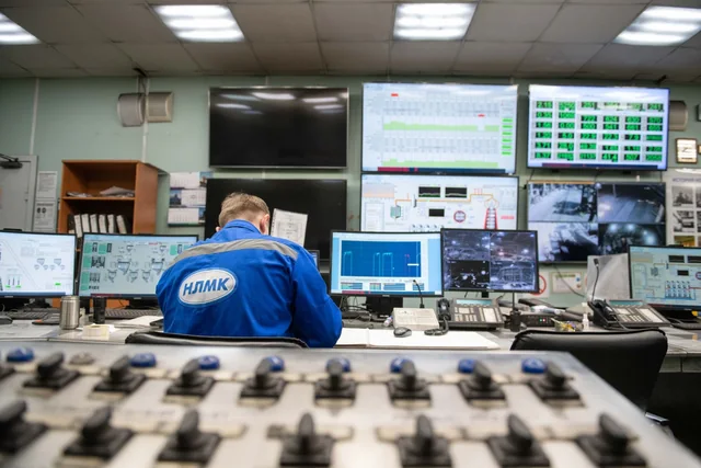 Engineer at an industrial control room desk