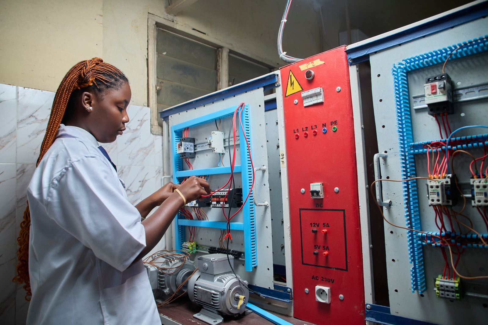 Electricians carrying out preventive maintenance on a distribution board